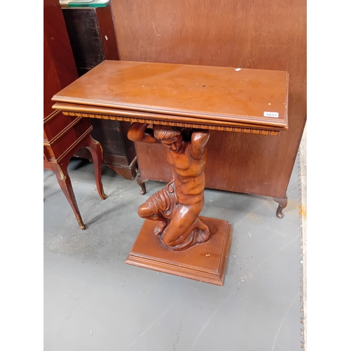 1057 - A mahogany swivel top side table with Greek God central pillar.