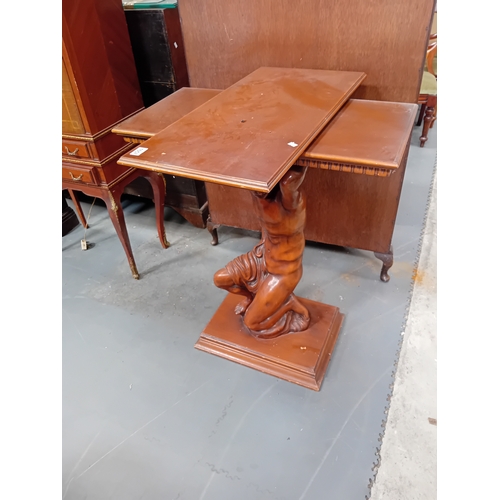 1057 - A mahogany swivel top side table with Greek God central pillar.