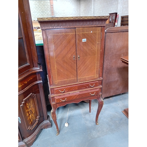 1056 - A French style mahogany drinks cabinet with gilt decoration.