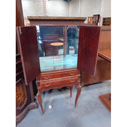 1056 - A French style mahogany drinks cabinet with gilt decoration.