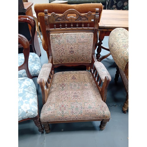 1078 - A Victorian oak chaise longue and matching arm chair.