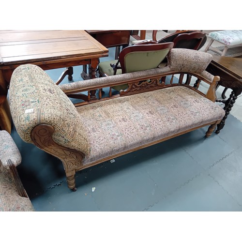 1078 - A Victorian oak chaise longue and matching arm chair.