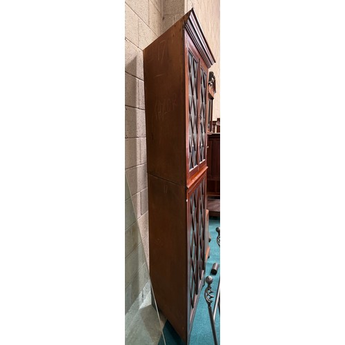 994 - A large repro mahogany double corner cabinet, with dentil cornice over astragal glazed pair of cupbo... 