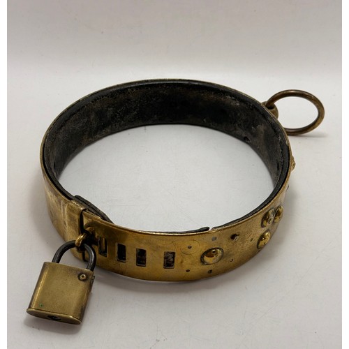 458 - A large 19th Century brass dog collar, adjustable, with applied domed studs, ring fixing and padlock... 