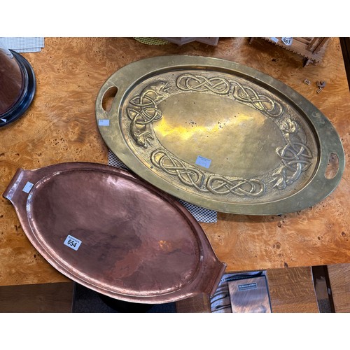 654 - An Arts and Crafts style copper two-handled tray, oval, the scroll-end handles with brass cylindrica... 