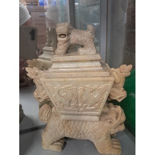 217 - A collection of oriental soapstone carvings including figural models, three Buddha figures, a boat, ... 
