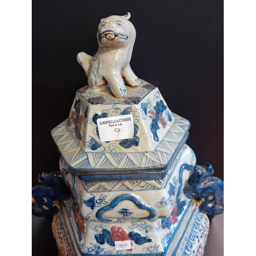 9 - A pair of Chinese porcelain Hexagonal temple jars with kylin shaped handles and lids. An ear is miss... 