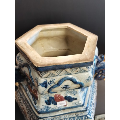 9 - A pair of Chinese porcelain Hexagonal temple jars with kylin shaped handles and lids. An ear is miss... 