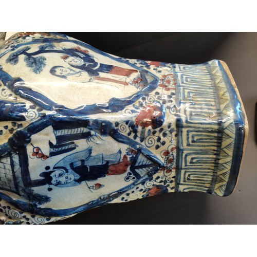 9 - A pair of Chinese porcelain Hexagonal temple jars with kylin shaped handles and lids. An ear is miss... 