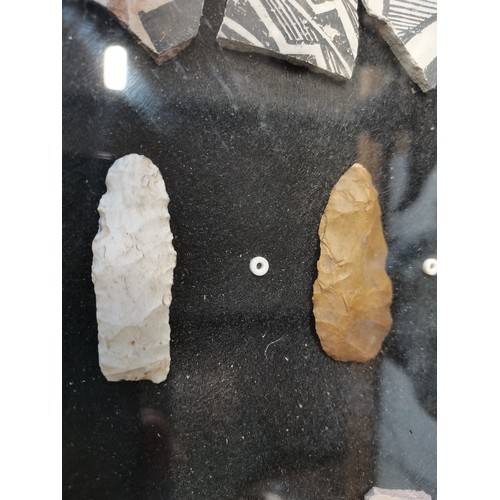 12 - A framed display containing Native American Anasazi pottery shards and some stones. H