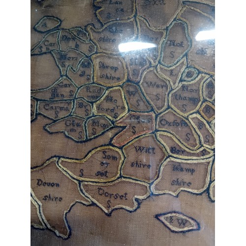 23 - George III oval needlework map sampler of England and Wales dated 1786.  H 36cm W 33cm.