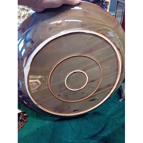 24 - Large contemporary studio pottery charger or shallow bowl.  The surface is glazed with a multi colou... 