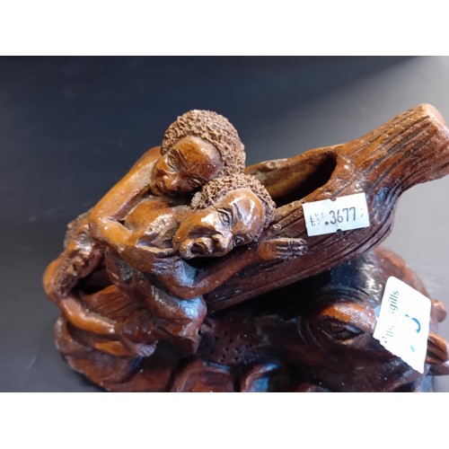 28 - Hand carved wooden sculpture.  Depicting a scene of figures trying to board a log/raft to escape a c... 