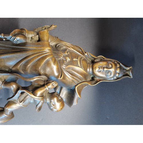 27 - A cast bronze statue of Guanyin, the East Asian Bodhisattva of Mercy and Compassion.  H 40cm