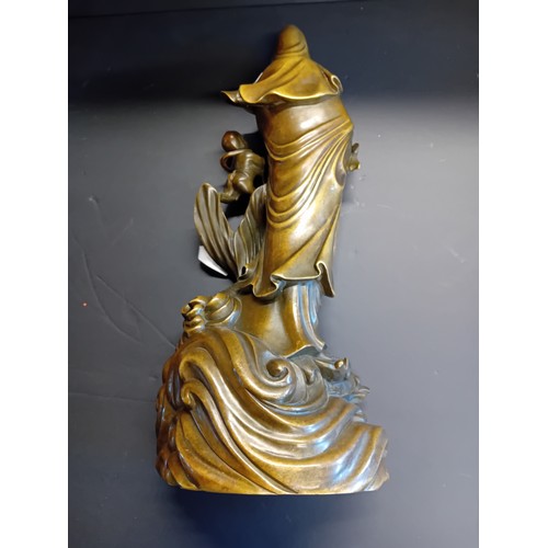27 - A cast bronze statue of Guanyin, the East Asian Bodhisattva of Mercy and Compassion.  H 40cm