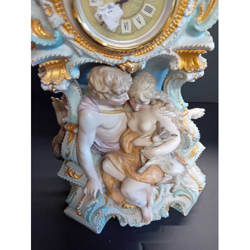 32 - Continental porcelain mantel clock.  Rococo style gilded details and figural sculptures.  Mercedes c... 