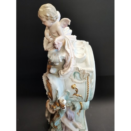 32 - Continental porcelain mantel clock.  Rococo style gilded details and figural sculptures.  Mercedes c... 