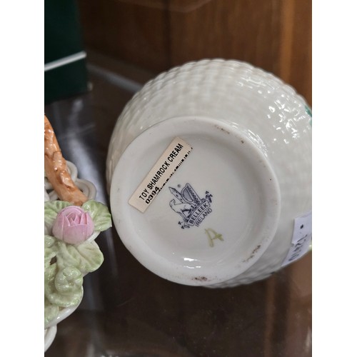 177 - A collection of Belleek comprising a harp, two jugs, a pig and a basket, all with boxes
