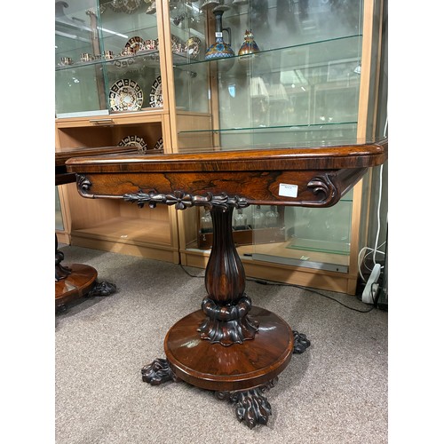 598 - A pair of William IV rosewood pedestal card tables, having a carved frieze above swept support on ci... 