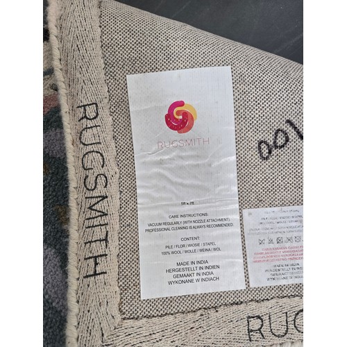 858 - A 100% Wool rug by Rugsmith with vibrant abstract floral patterns 152cm x 213cm