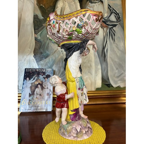 85 - A Meissen style continental figure group of a woman and child, the woman's arms supporting a pierced... 