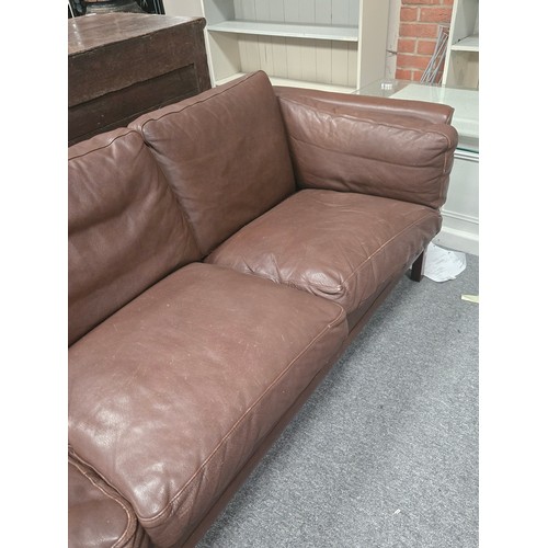 885 - A Mid-century Danish chocolate brown leather three seater settee. W216cm