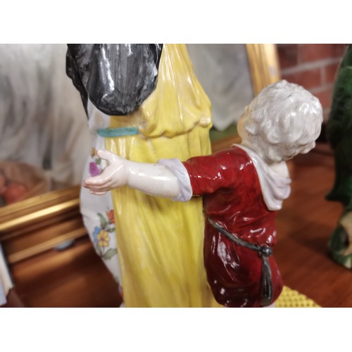 85 - A Meissen style continental figure group of a woman and child, the woman's arms supporting a pierced... 