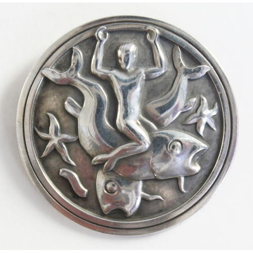 104 - A Georg Jensen Sterling silver brooch depicting a boy riding a fish no 285, London import marks 1965... 