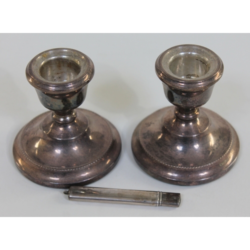 109 - Hallmarked silver comprising a pair of candlesticks and a pencil