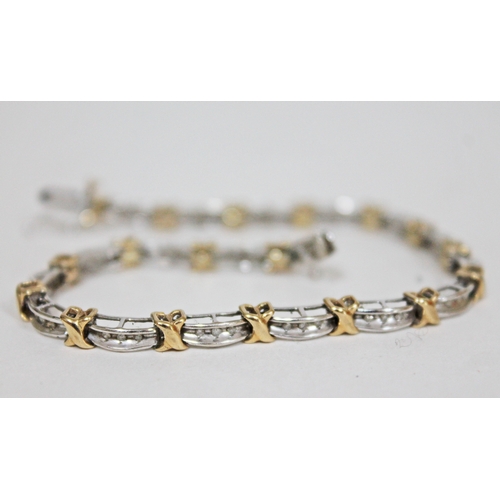 121 - A hallmarked 9ct white & yellow gold diamond bracelet, length 19cm, gross wt. 8.6g.