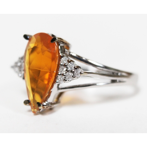 137 - A 9ct white gold fire opal and diamond ring, the oval cut central stone approx. 1.59 carats, diamond... 