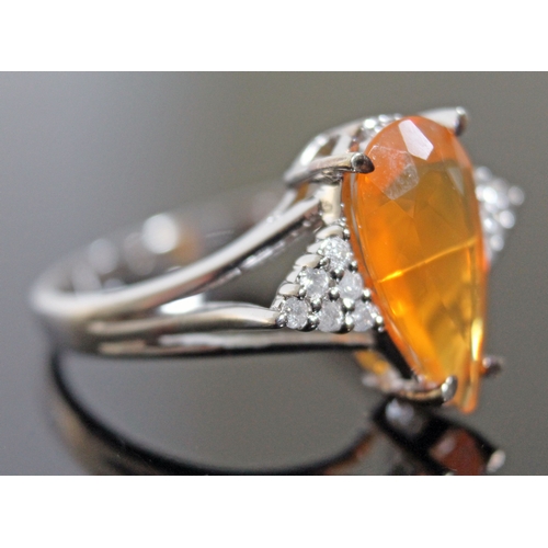 137 - A 9ct white gold fire opal and diamond ring, the oval cut central stone approx. 1.59 carats, diamond... 