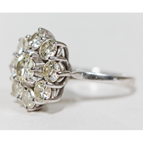 138 - A diamond round cluster ring, the central round brilliant cut and bezel set stone approx. 0.50 carat... 