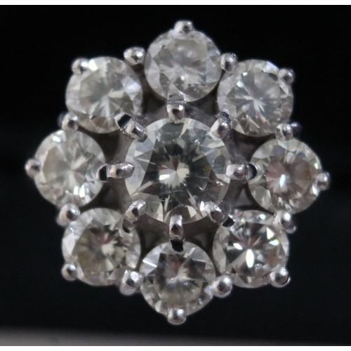 138 - A diamond round cluster ring, the central round brilliant cut and bezel set stone approx. 0.50 carat... 