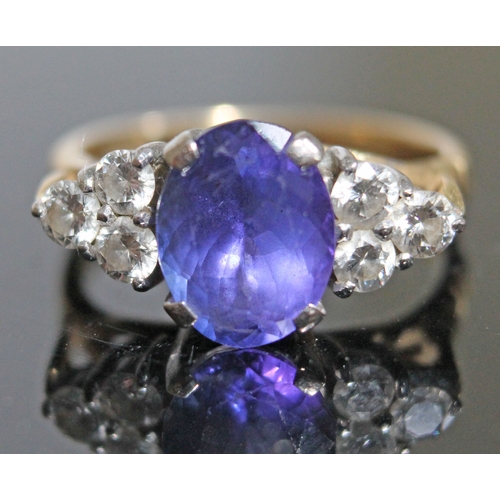 139 - A tanzanite and diamond ring, the oval cut central stone approx. 2.50 carats, set with diamond shoul... 