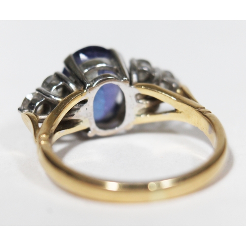 139 - A tanzanite and diamond ring, the oval cut central stone approx. 2.50 carats, set with diamond shoul... 