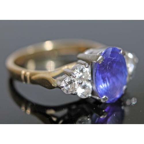 139 - A tanzanite and diamond ring, the oval cut central stone approx. 2.50 carats, set with diamond shoul... 