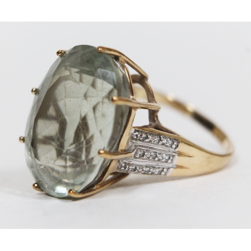 140 - An amethyst and diamond ring, the central pale green stone approx. 21.50 carats, basket set with dia... 