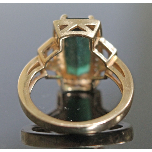 141 - A tourmaline and diamond ring, the central mid green stone approx. 2.90 carats, hallmarked 18ct gold... 