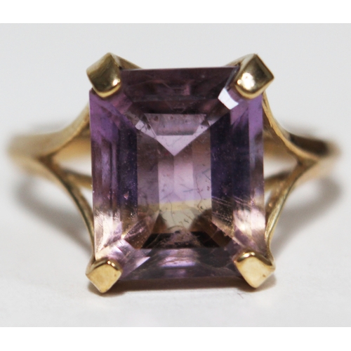 146 - A modern hallmarked 9ct gold ring set with a purple stone, gross wt. 2.9g, size N.