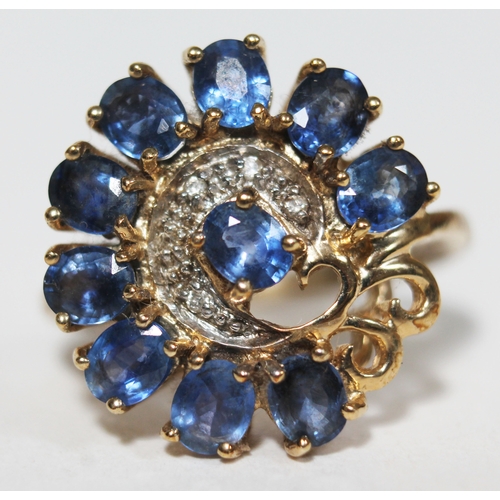 148 - A sapphire and diamond ring, 10 oval cut stones wt. approx. 2.50 carats, surrounding a diamond chip ... 