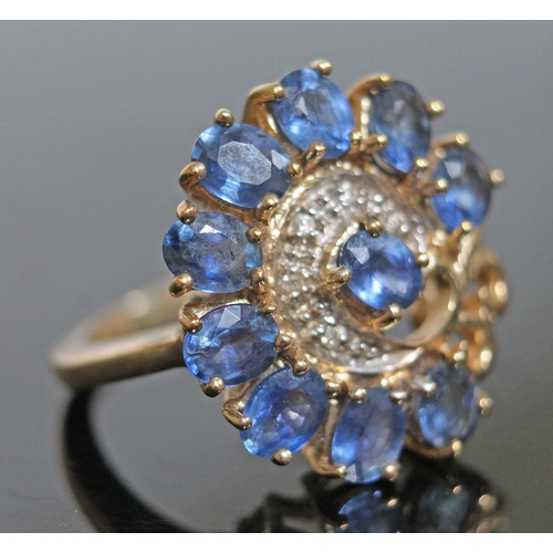 148 - A sapphire and diamond ring, 10 oval cut stones wt. approx. 2.50 carats, surrounding a diamond chip ... 