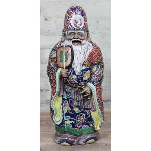 347 - A large Chinese porcelain figure formed as a bearded man wearing a hat and gown and holding a fan, 2... 