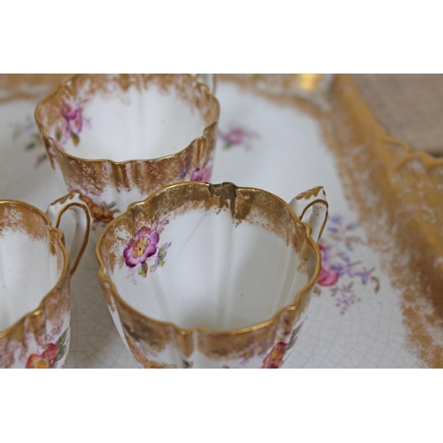 369 - An Aynsley tea set decorated in floral sprays and gilding comprising 5 cups, 6 saucers, milk, sugar,... 