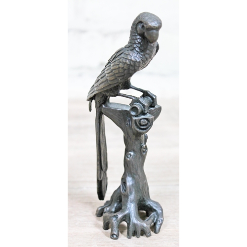 371 - A bronze figure formed as a parrot perched on a tree stump, height 18cm.