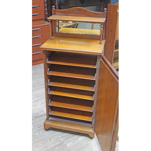 68 - A late Victorian Aesthetic music cabinet with mirror panelled door, superstructure with mirror back ... 