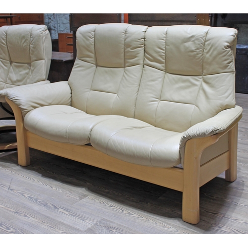 71 - A Norwegian Ekornes Stressless cream leather and wood frame two seater reclining seater.