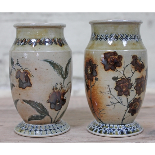 390 - A pair of Martin Brothers stoneware vases by Robert Wallace Martin, each decorated in floral designs... 