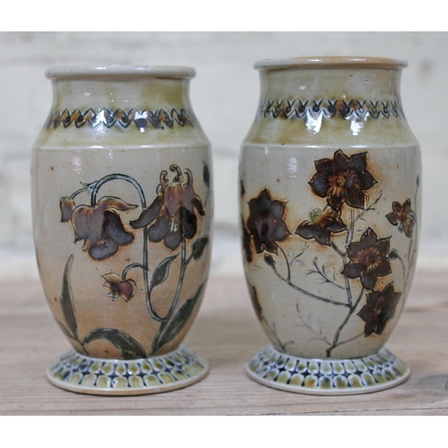 390 - A pair of Martin Brothers stoneware vases by Robert Wallace Martin, each decorated in floral designs... 