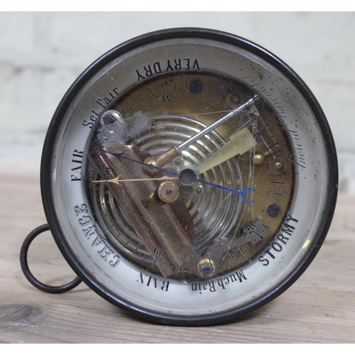 395 - An aneroid barometer, diam. 14cm.